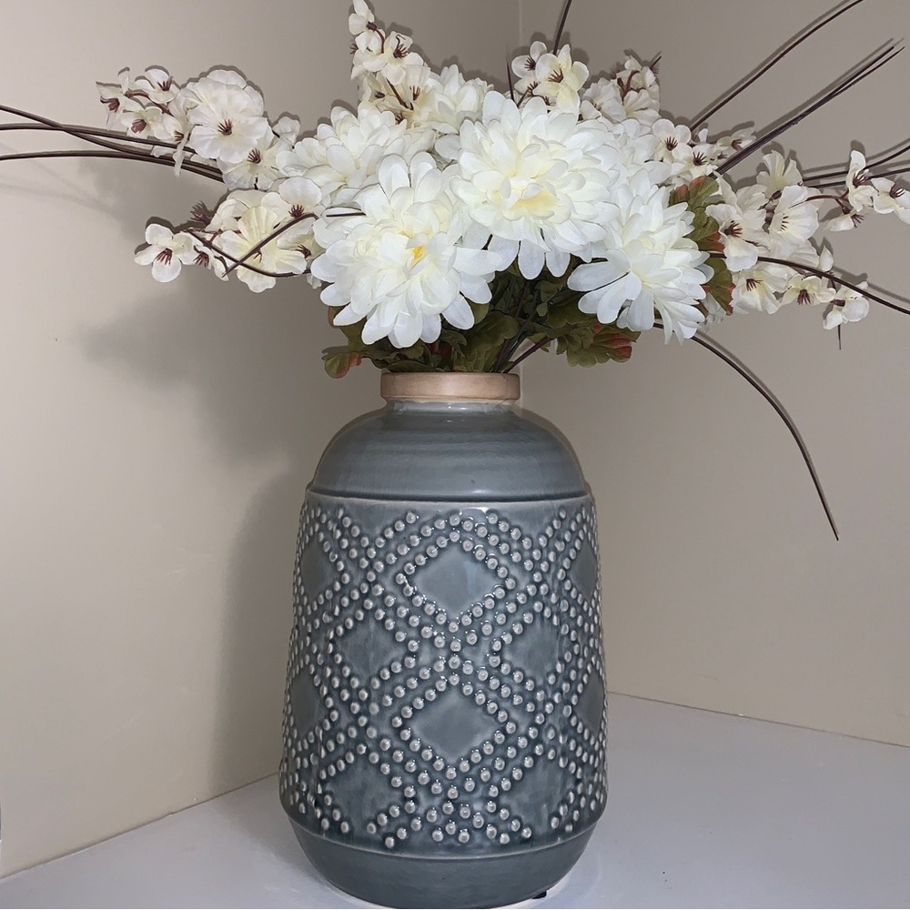 Teal blue vase with white flowers